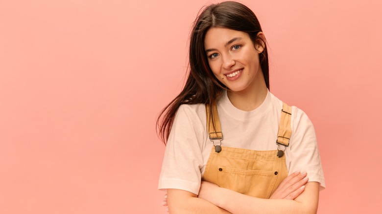 Woman in overalls smiling 