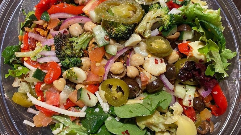 Vegan salad with chickpeas, olives, tomatoes, and other veggies