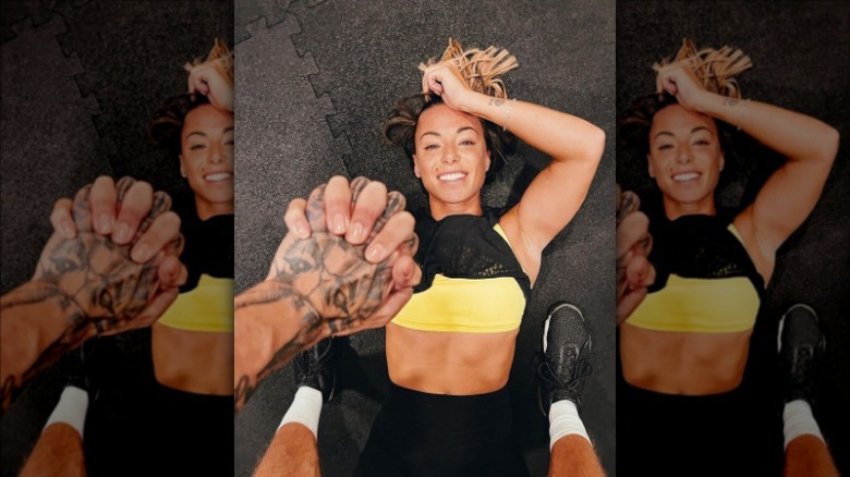 Woman lying on the floor and smiling after finishing her workout