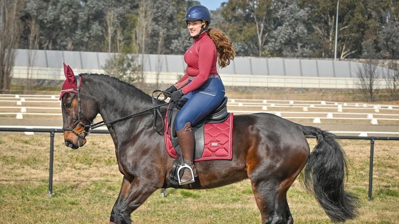 Woman riding a horse outdoors 