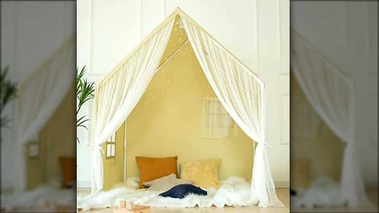 White indoor fort with sheer curtains