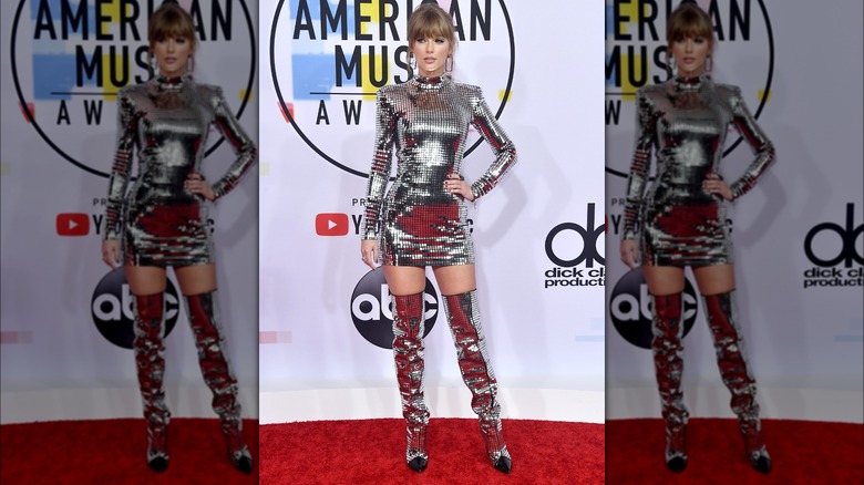 Taylor Swift poses in metallic dress with boots