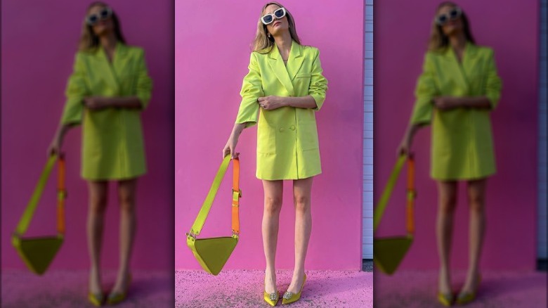 Model in a bright yellow blazer and skirt