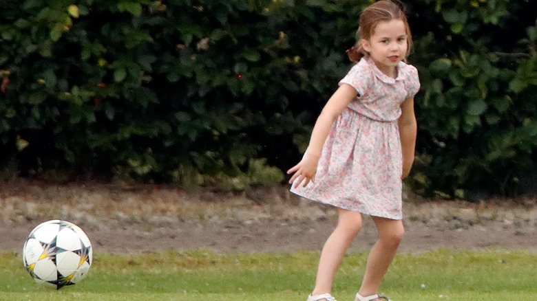 Princess Charlotte kicking a soccer ball