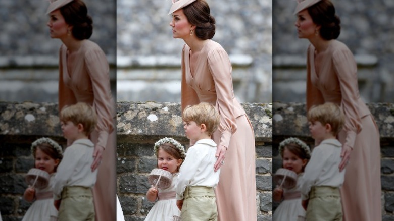 Princess Catherine ushering Princess Charlotte and Prince George