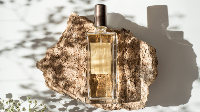 Perfume bottle on a stone
