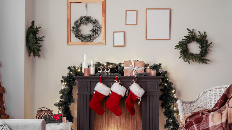 Fireplace decorated with several small wreaths