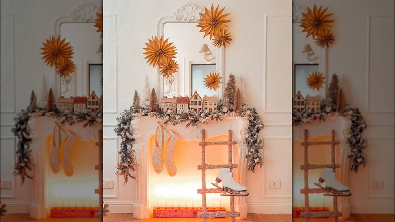 White fireplace decorated with a small village