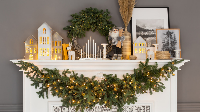 Fireplace mantel decorated with different types of Christmas decor