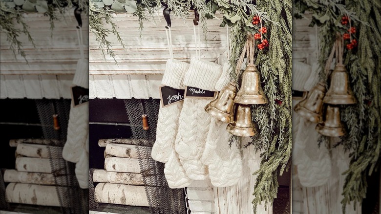 Decorative bells hanging with garland next to stockings