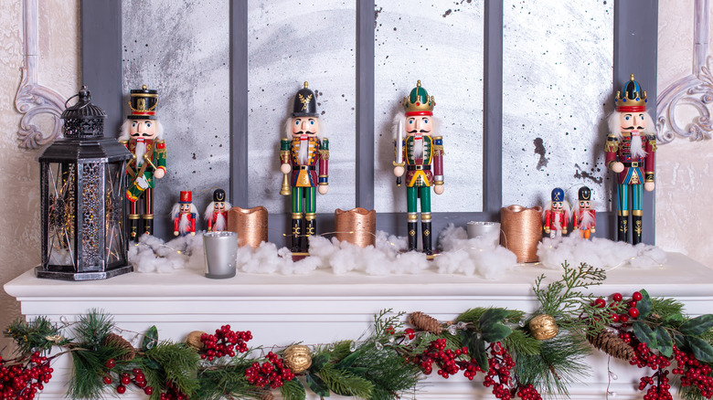 Fireplace mantel decorated with nutcracker figures and fake snow