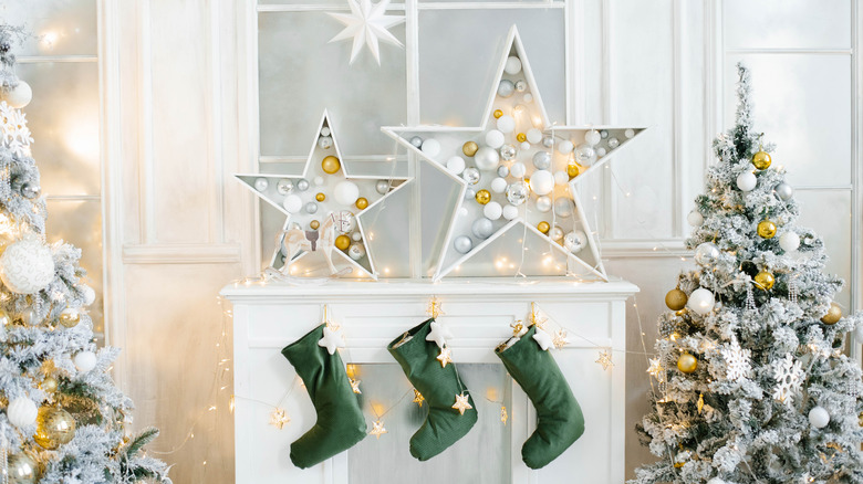 Decorative stars with ornaments placed on mantel over green stockings