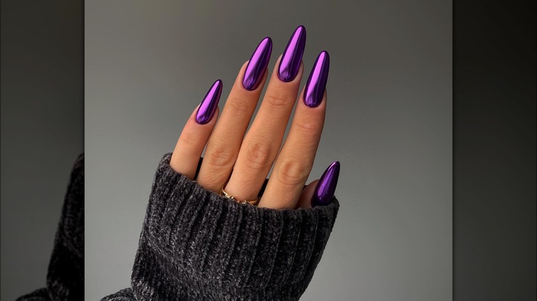 Hand with purple, chrome nail polish