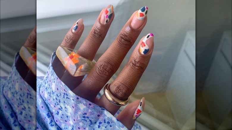 Hand showing colorful nail design