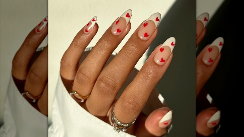 French manicure featuring red hearts