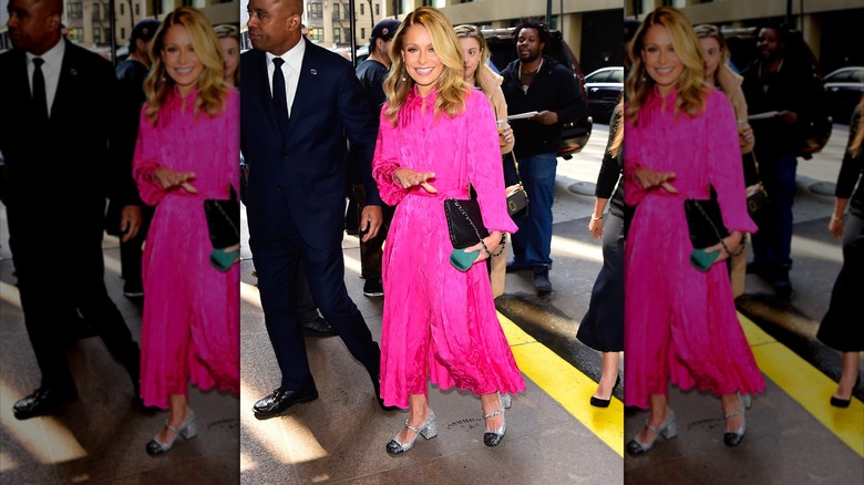 Kelly Ripa walking and smiling in pink dress 