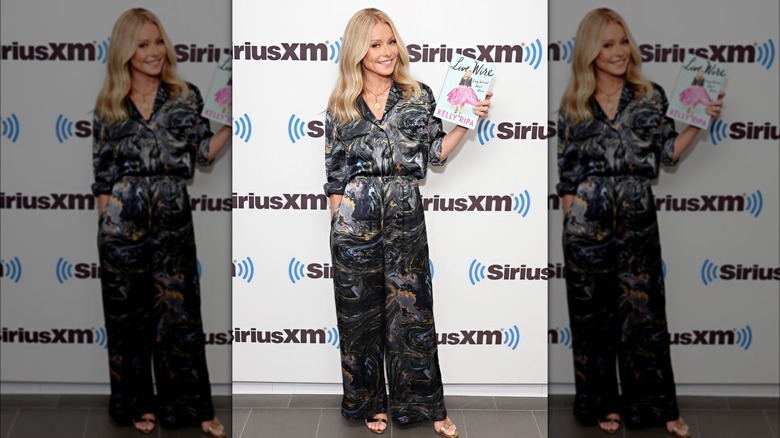 Kelly Ripa holding her book and smiling 