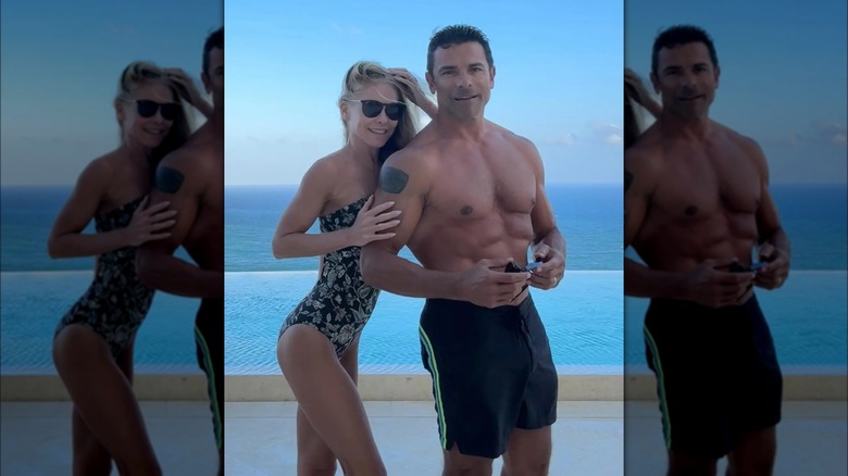 Kelly Ripa smiling with husband Mark Consuelos in bathing suits