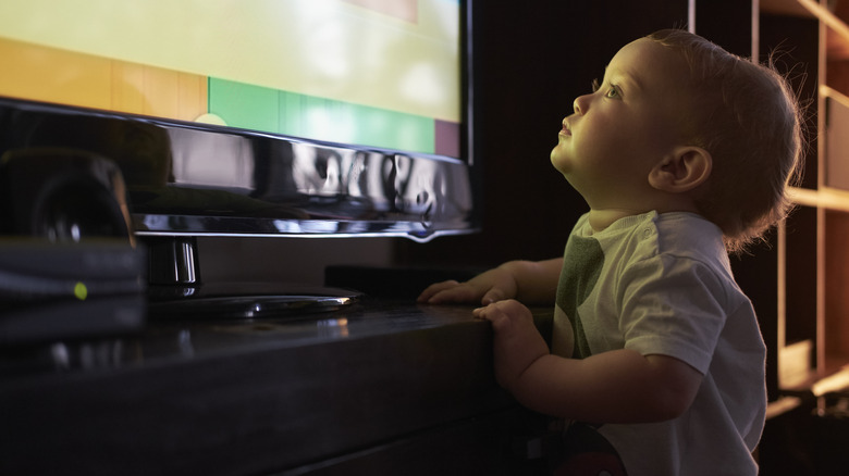 baby looking up at TV