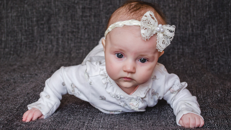 baby girl against gray background
