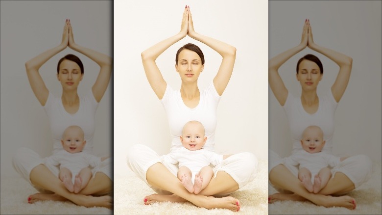 mom doing yoga with baby