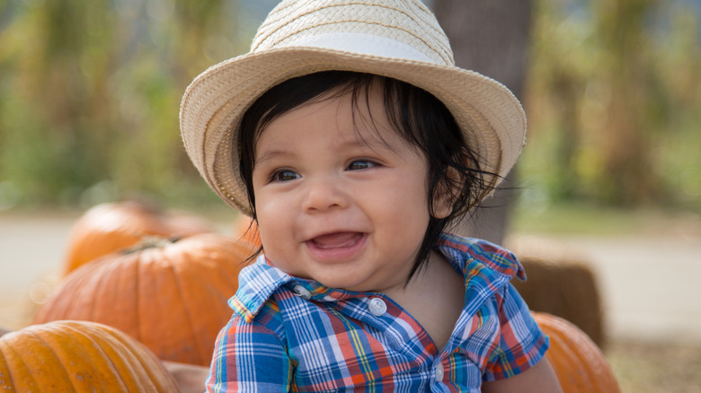 baby in pumpkin patch