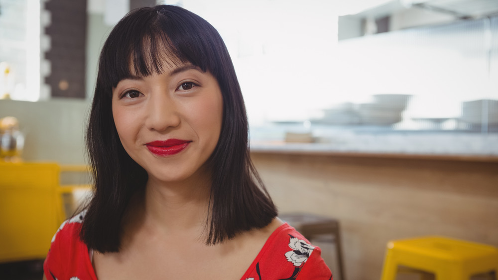 A woman with bangs wearing lipstick