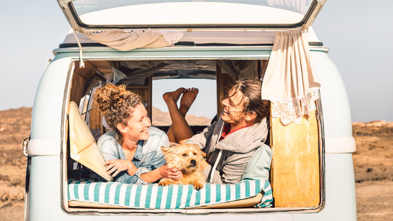 Couple in van with dog