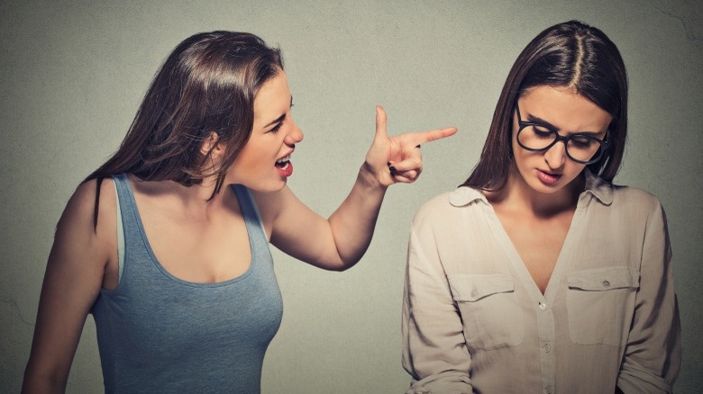 woman antagonizing another woman fight yelling