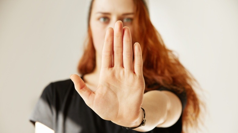 woman interrupting with hand up