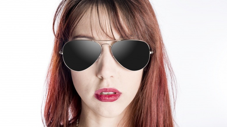 woman wearing dark sunglasses not responding unresponsive