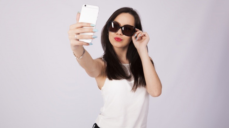 self-absorbed woman taking selfie