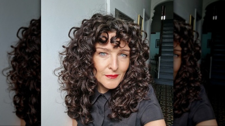 Woman with curly lob smiling