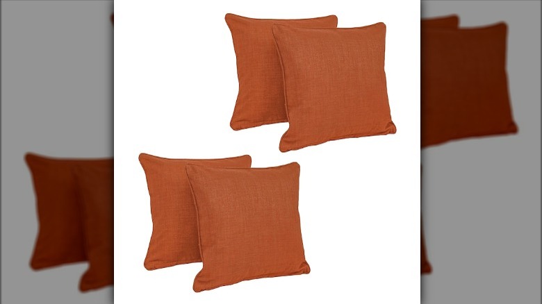 Four cinnamon colored throw pillows