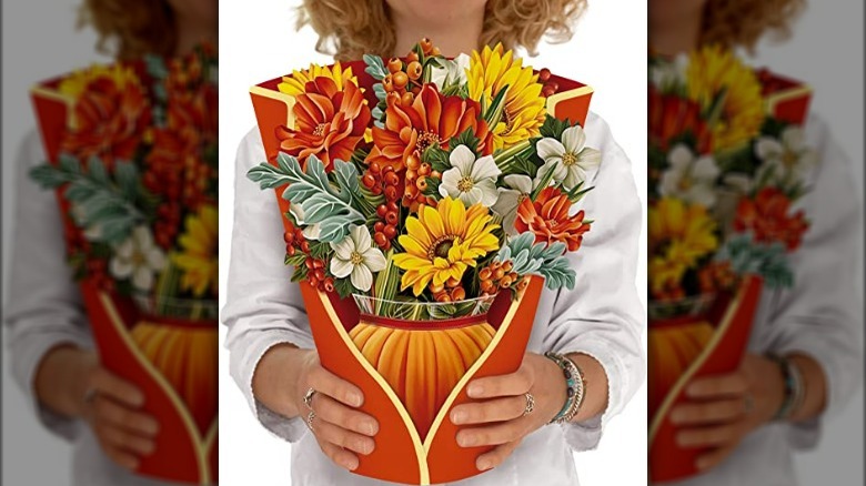 Person holding a 3 dimensional paper pumpkin-themed bouquet