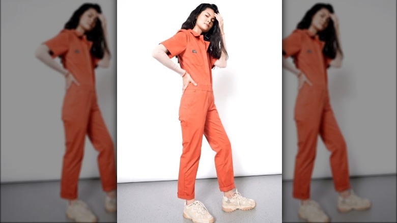 Brunette in orange coveralls