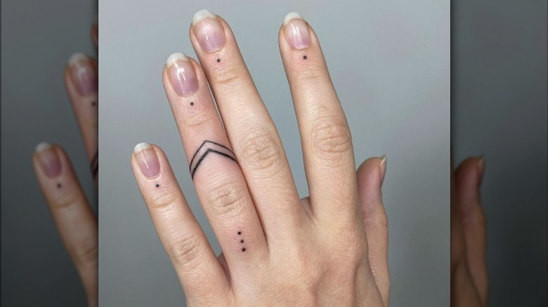 Hand with dot tattoos