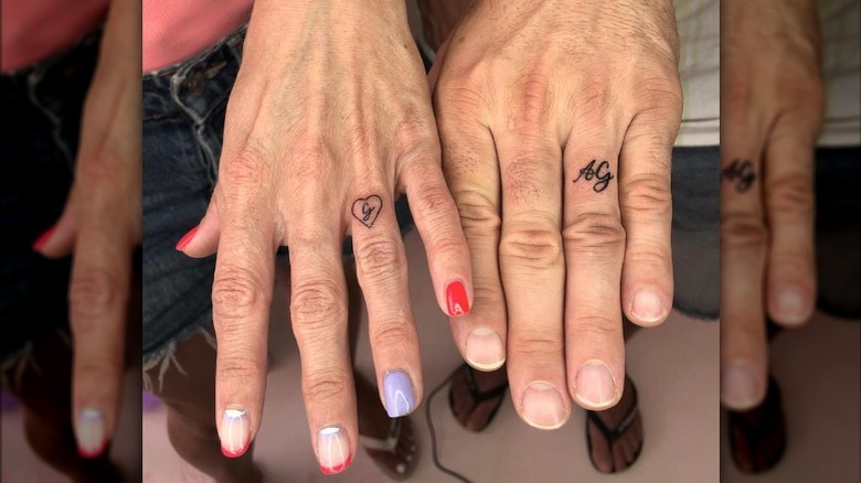 Hands with initial tattoos