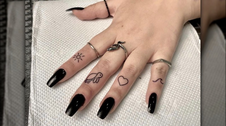 Hand with little symbol tattoos