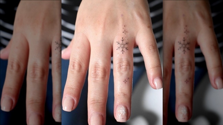 Hand with delicate snowflake tattoos