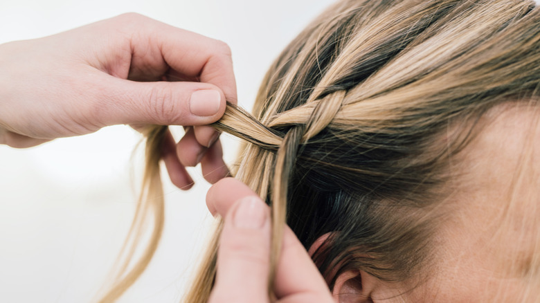 Woman braiding hair