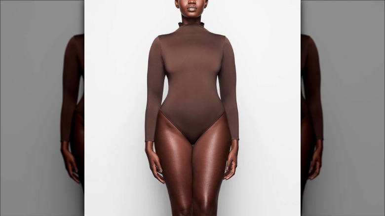 Skims model wears turtleneck bodysuit