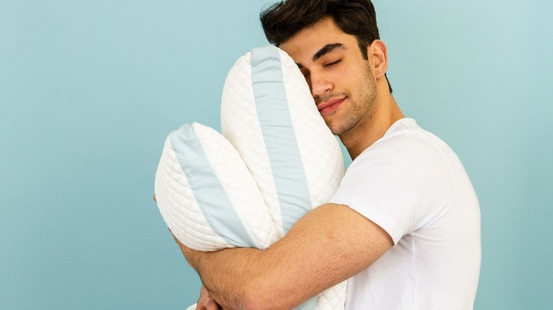 Man hugging a pillow