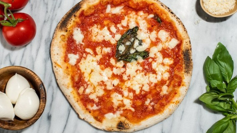 Pizza display with fresh mozzarella and tomatoes 