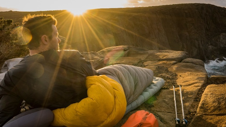 Sunny scene with a man in sleeping bag 