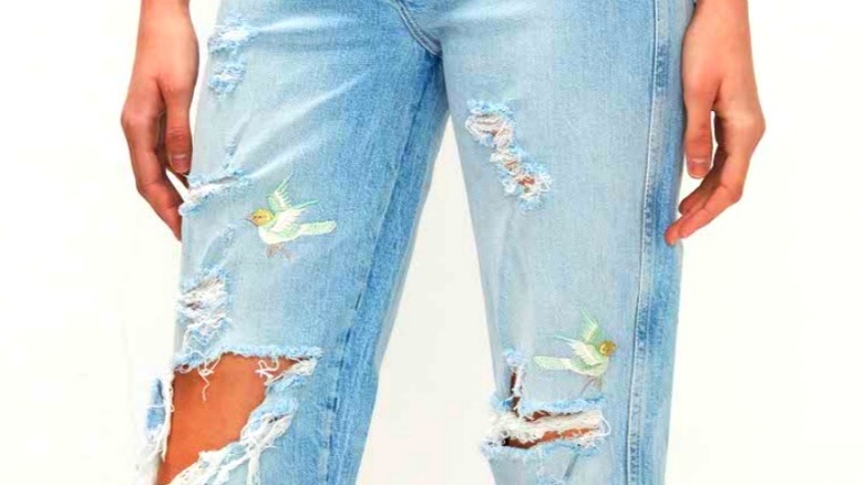 Model wear jeans embellished with birds