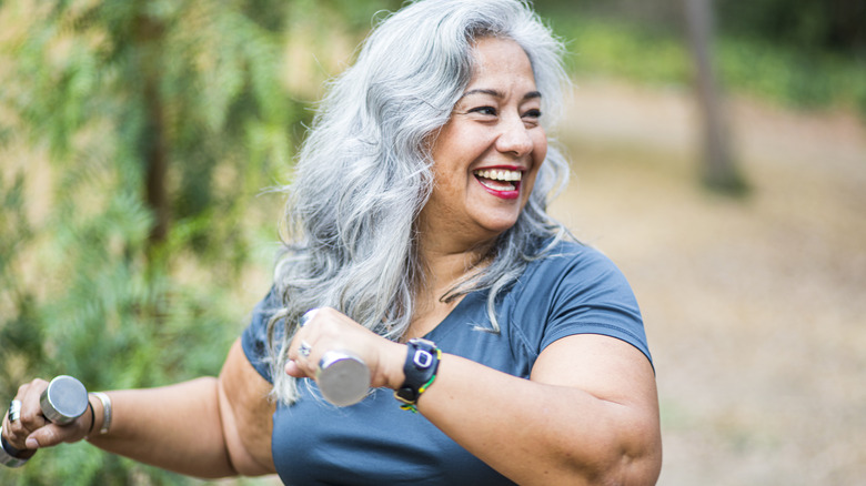 gray haired woman exercising outside