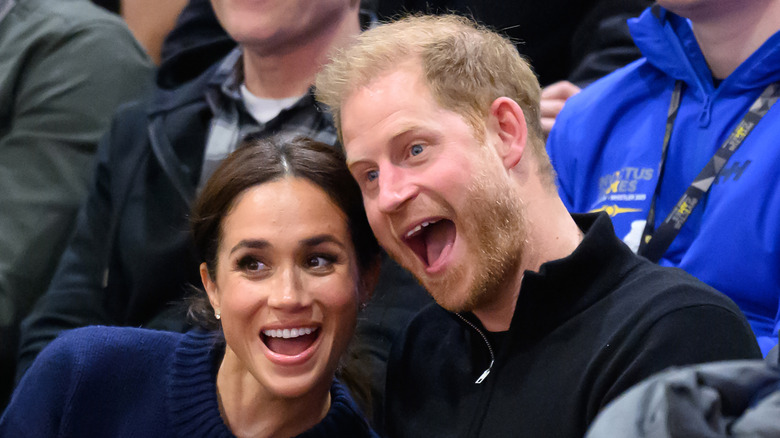 Meghan Markle and Prince Harry smile enthusiastically