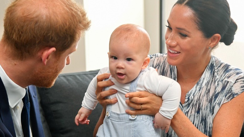 Prince Harry and his son Archie, held by mom, Meghan Markle