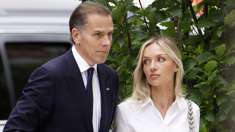 Hunter Biden and Melissa Cohen walking with downcast expressions at Delaware trial